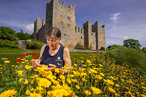 Elizabeth Carter with yellow flowers at Bolton Castle credit Garth Buddo